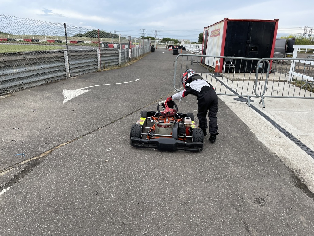 In the pit lane, setting up the kart